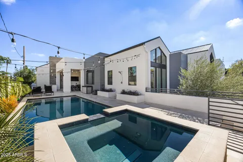 a living room with furniture and large windows