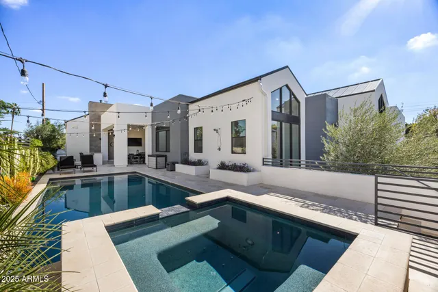 a living room with furniture and large windows