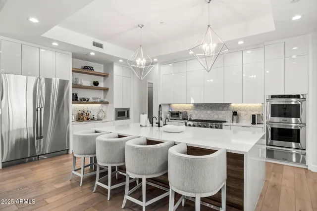 a large kitchen with a table and chairs