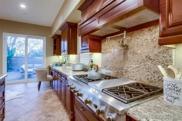 a kitchen with granite countertop a sink and cabinets