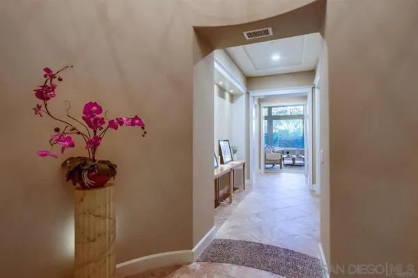 a view of a hallway and a livingroom with a chair
