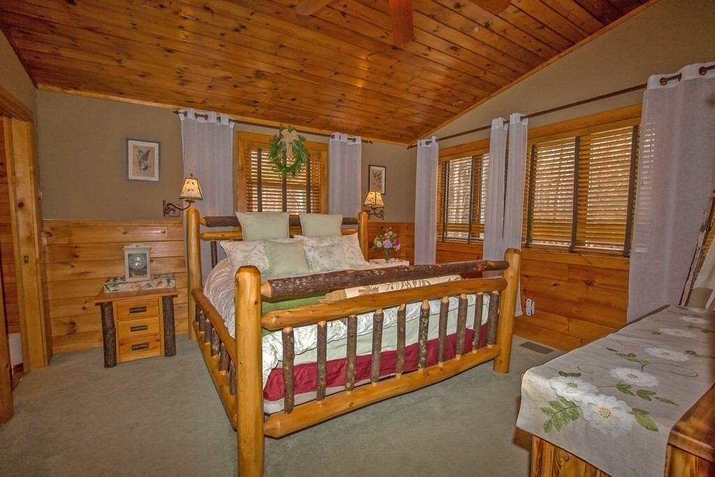 302 Fox Den Road Tolland, MA 01034 - Photo 19 of 41 a large bedroom with a bed a table and flat screen tv