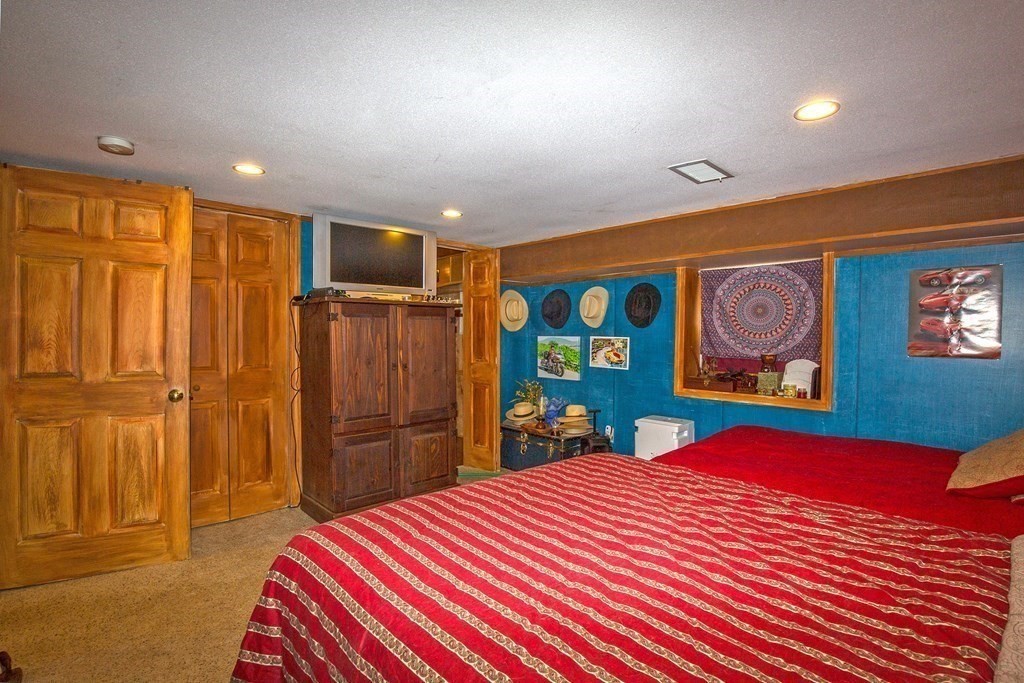 302 Fox Den Road Tolland, MA 01034 - Photo 34 of 41 a bedroom with a large bed and a closet