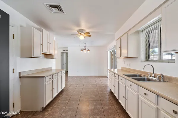 a kitchen with stainless steel appliances granite countertop a sink and cabinets