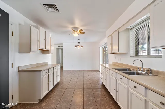 a kitchen with stainless steel appliances granite countertop a sink and cabinets