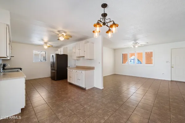 a view of a kitchen with a sink and a refrigerator