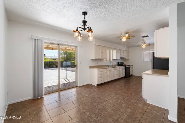 a view of a kitchen with furniture and natural light
