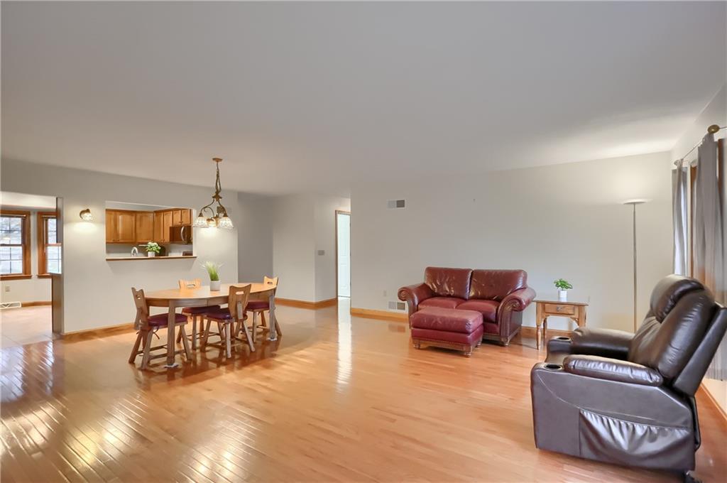 119 South Butler Street Saxonburg, PA 16056 - Photo 17 of 39 a living room with furniture and a dining table with wooden floor