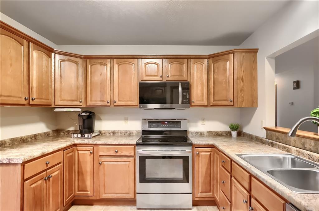 119 South Butler Street Saxonburg, PA 16056 - Photo 6 of 39 a kitchen with granite countertop a sink stainless steel appliances and cabinets