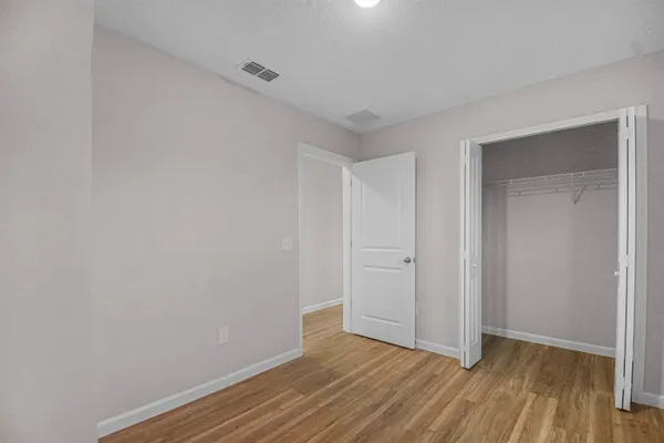 a view of an empty room and wooden floor