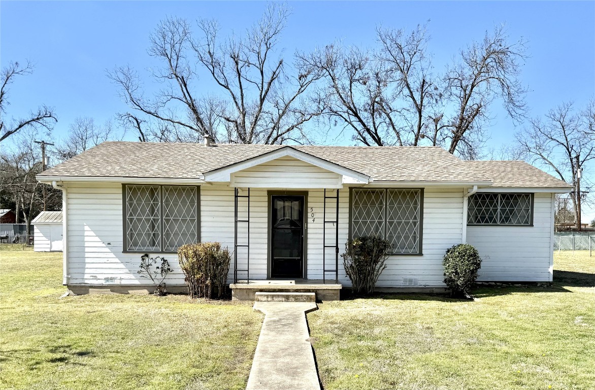 504 Alva Street Thrall, TX 76578 - Photo 1 of 1 a front view of a house with a yard outdoor seating and garage