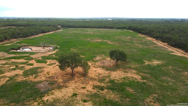 a view of a green field with clear sky