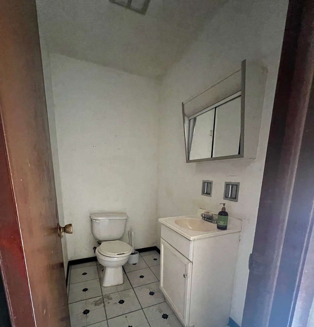 14425 Vail Avenue Harvey, IL 60426 - Photo 9 of 16 a bathroom with a toilet sink and mirror