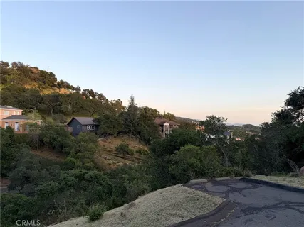 a view of a road with a trees in the background