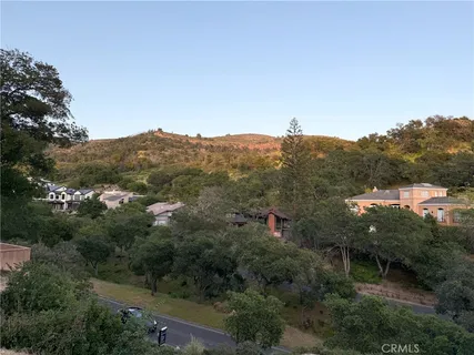 an aerial view of residential house with green space and mountain view