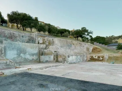 a view of street with a car parked on the road