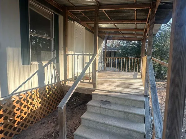 a view of entryway with a floor to ceiling window and wooden floor
