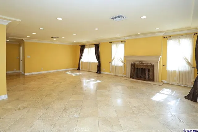 a view of empty room with a fireplace and a floor to ceiling window