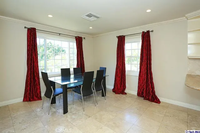 a view of a dining room with furniture and a large window