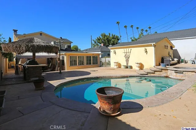 a swimming pool with outdoor seating
