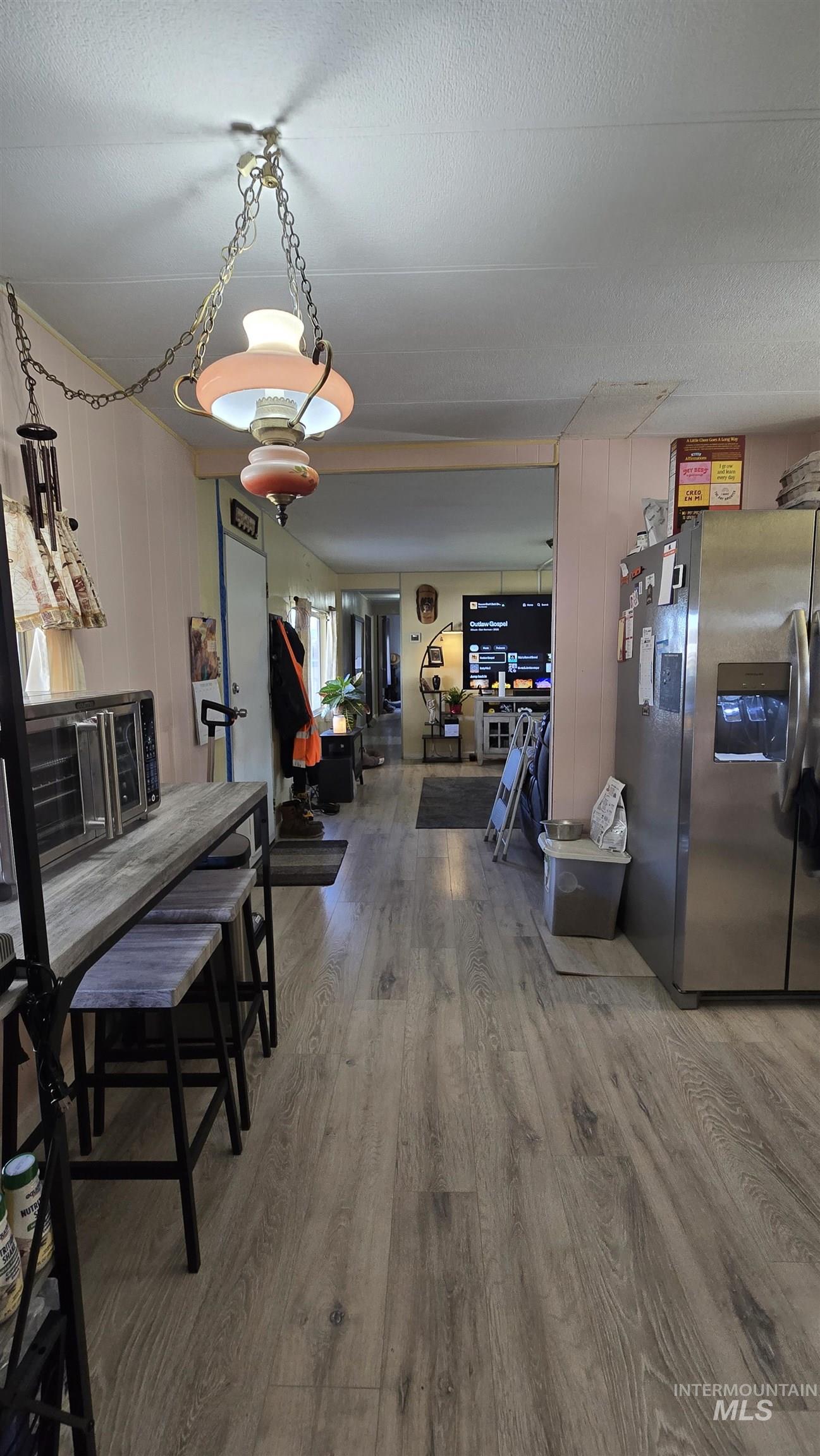 798 Dolson Lane Eagle, ID 83616 - Photo 16 of 33 Dining area with light wood-style floors and a textured ceiling