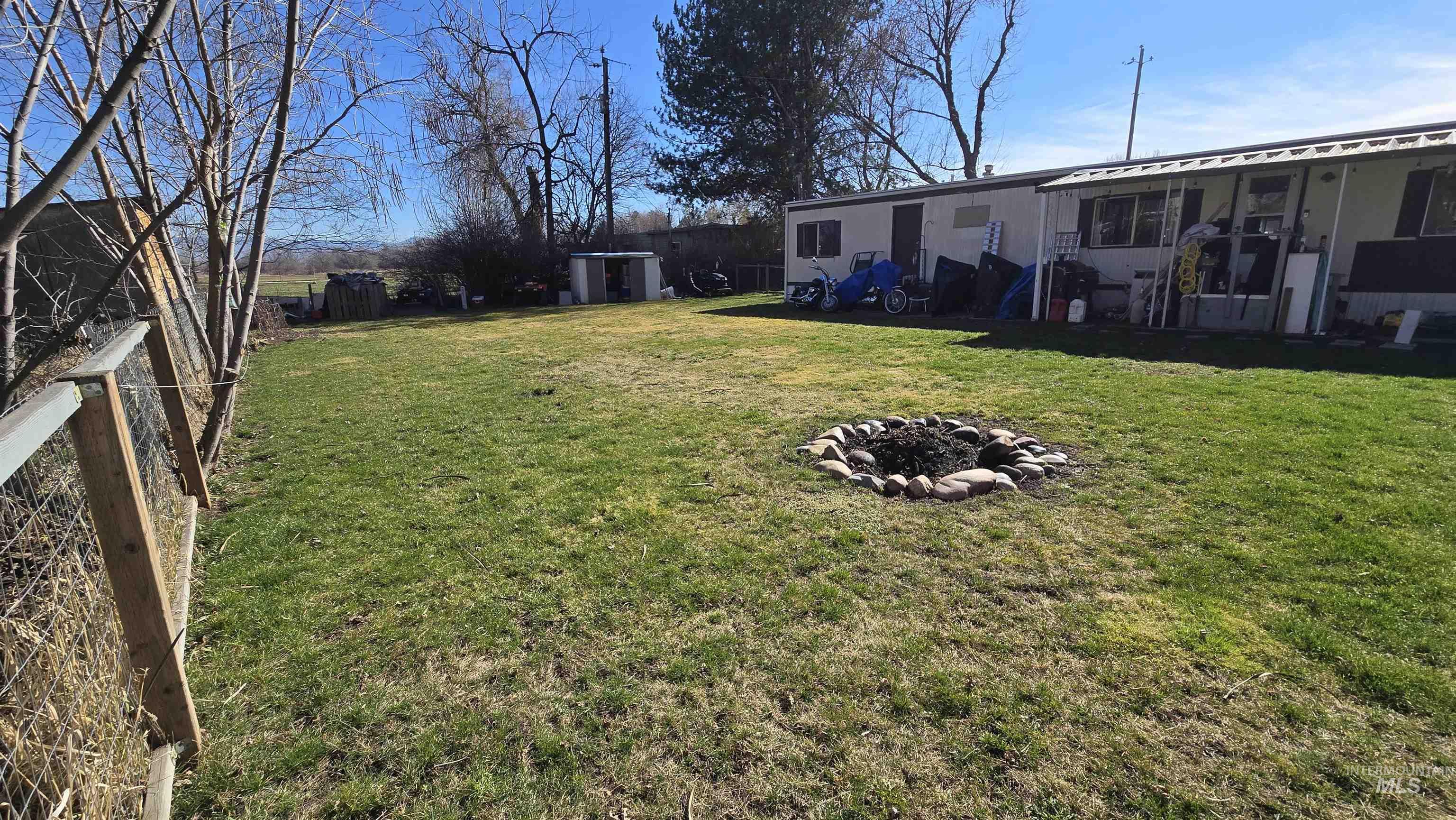 798 Dolson Lane Eagle, ID 83616 - Photo 28 of 33 Fenced backyard featuring a fire pit and a storage unit