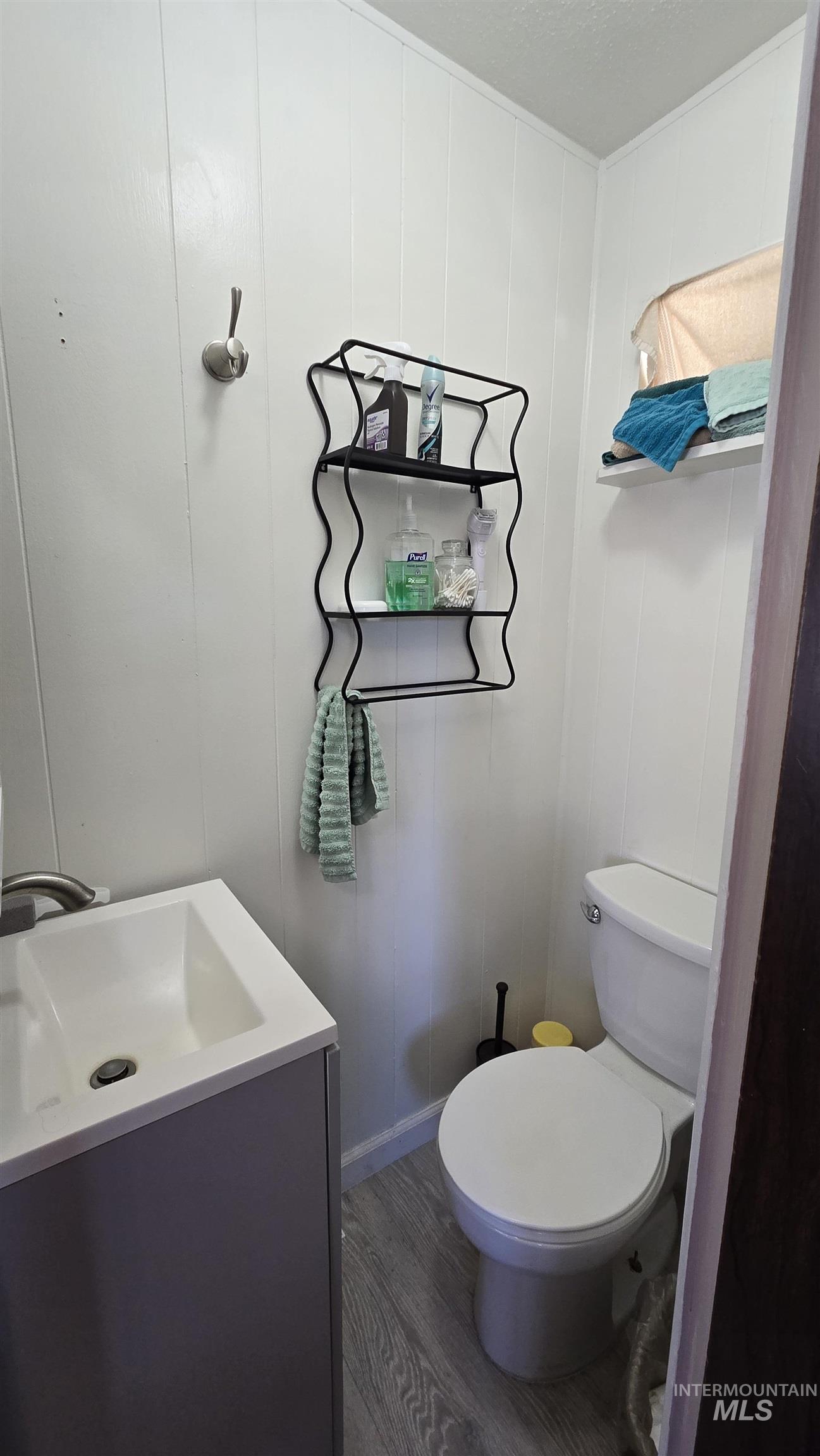 798 Dolson Lane Eagle, ID 83616 - Photo 10 of 33 Half bathroom featuring vanity and dark wood-type flooring