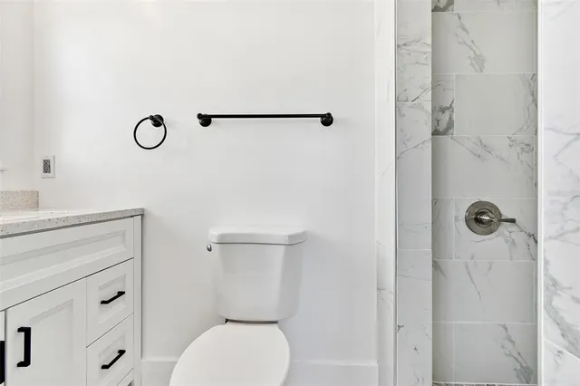 a bathroom with a toilet and a shower curtain