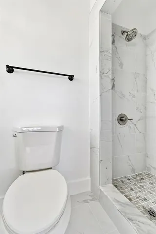 a white toilet sitting next to a bathroom sink