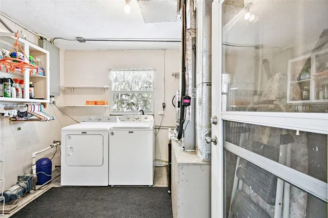 a utility room with cabinets washer and dryer