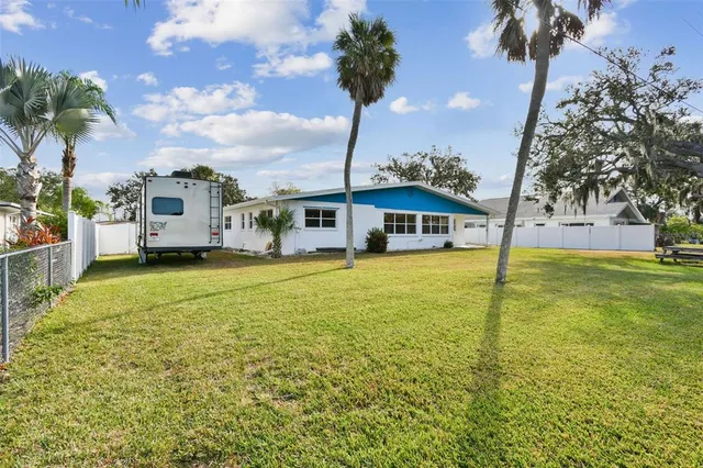 a front view of house with yard and swimming pool