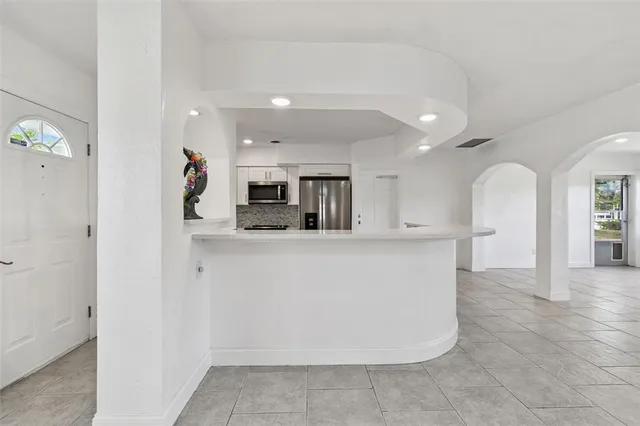 a view of kitchen with refrigerator and window