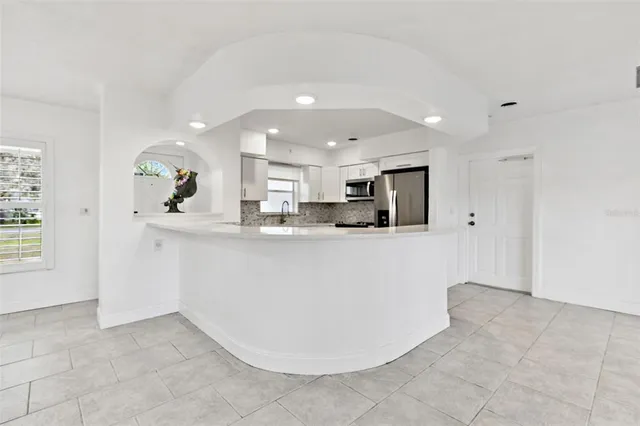 a view of kitchen with refrigerator and window