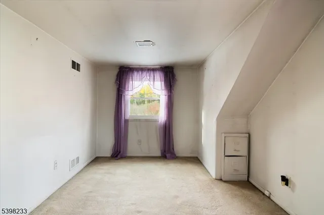 an empty room with windows and closet