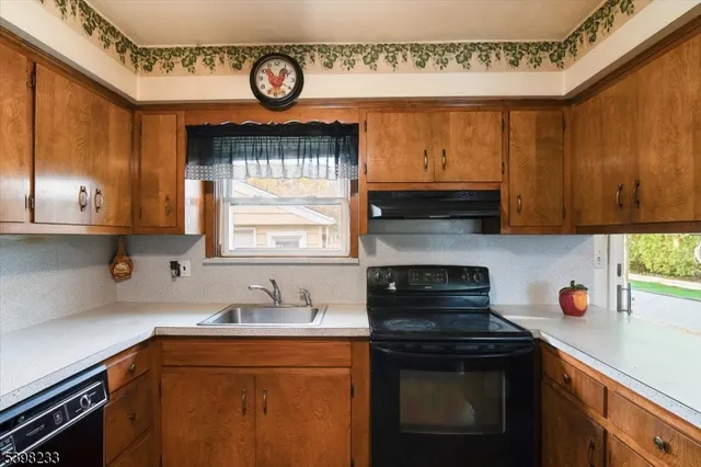 a kitchen with stainless steel appliances granite countertop a sink a stove and a microwave