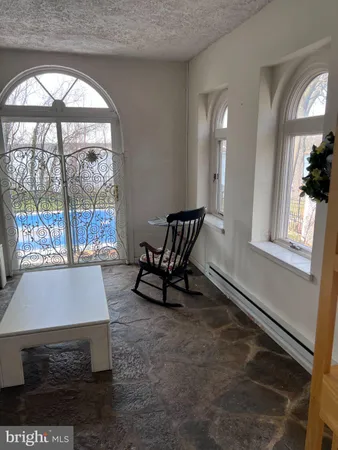 a living room with a window and a table
