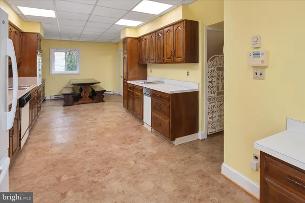 a view of empty room with a fireplace and wooden floor