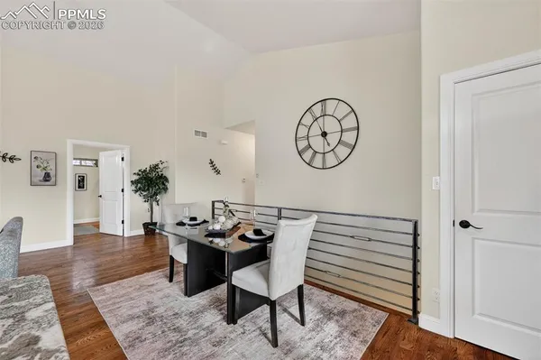 a view of a dinning room with furniture and wooden floor