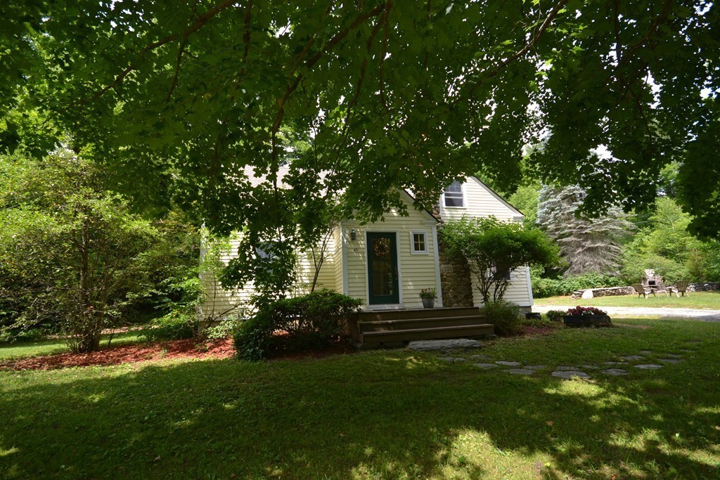 45 River Road Worthington, MA 01098 - Photo 3 of 28 a front view of a house with a garden