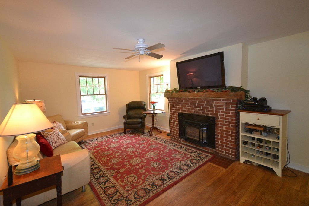 45 River Road Worthington, MA 01098 - Photo 7 of 28 a living room with furniture a flat screen tv and a fireplace