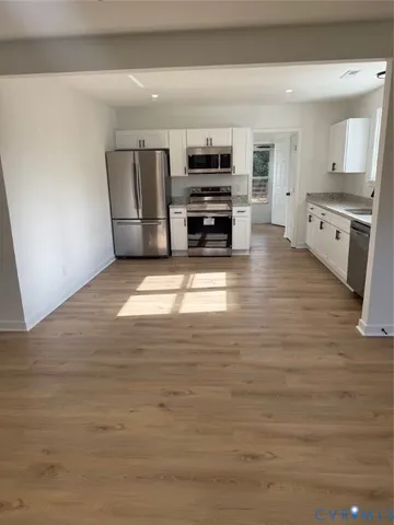 a kitchen with stainless steel appliances a refrigerator and a stove