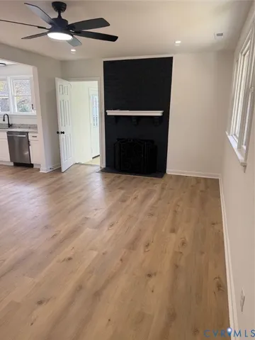 an empty room with fireplace and windows