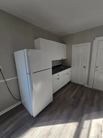 a kitchen with granite countertop a refrigerator and a stove