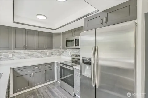 a kitchen with a sink appliances and cabinets