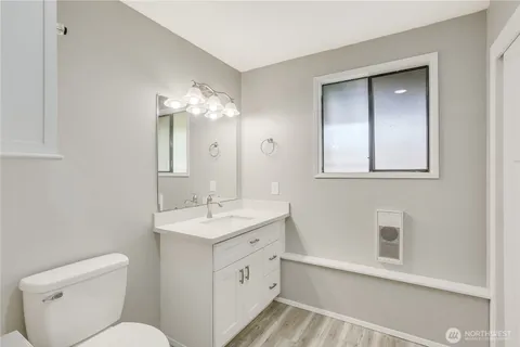 a bathroom with a toilet sink and mirror