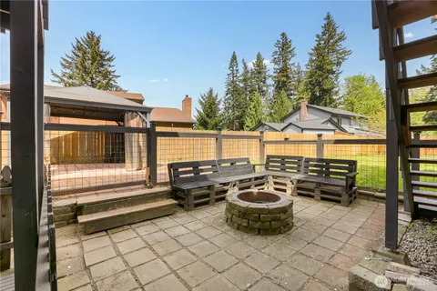 a view of a patio with table and chairs and potted plants