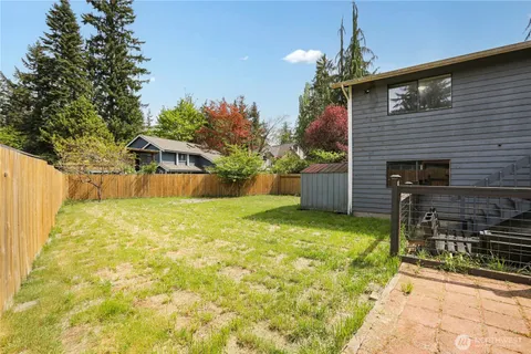 a backyard of a house with table and chairs