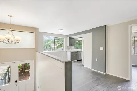 a view of hallway with furniture and a window