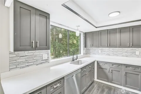 a kitchen with a sink and cabinets