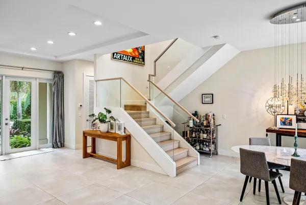 a bathroom with a granite countertop sink a toilet a mirror and shower